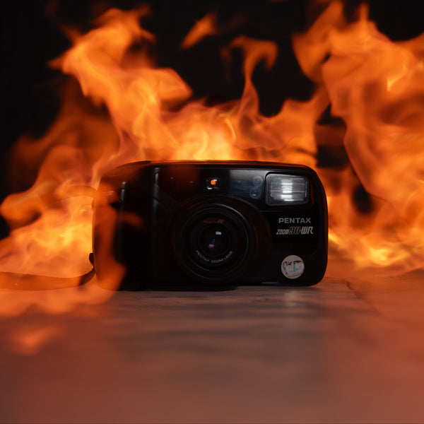 Camera in front of flames on a dark background